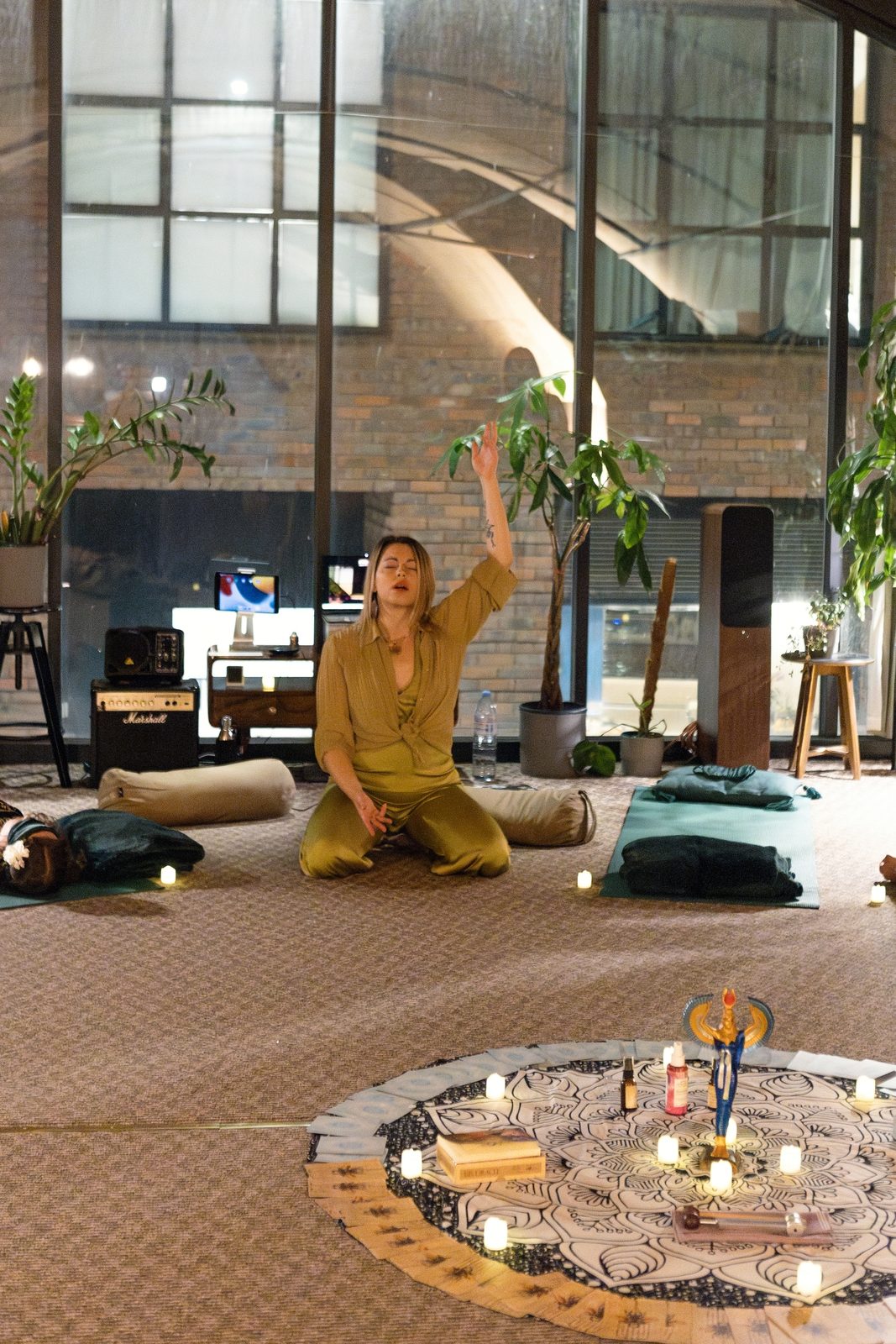Monika facilitating beside the candlelit altar