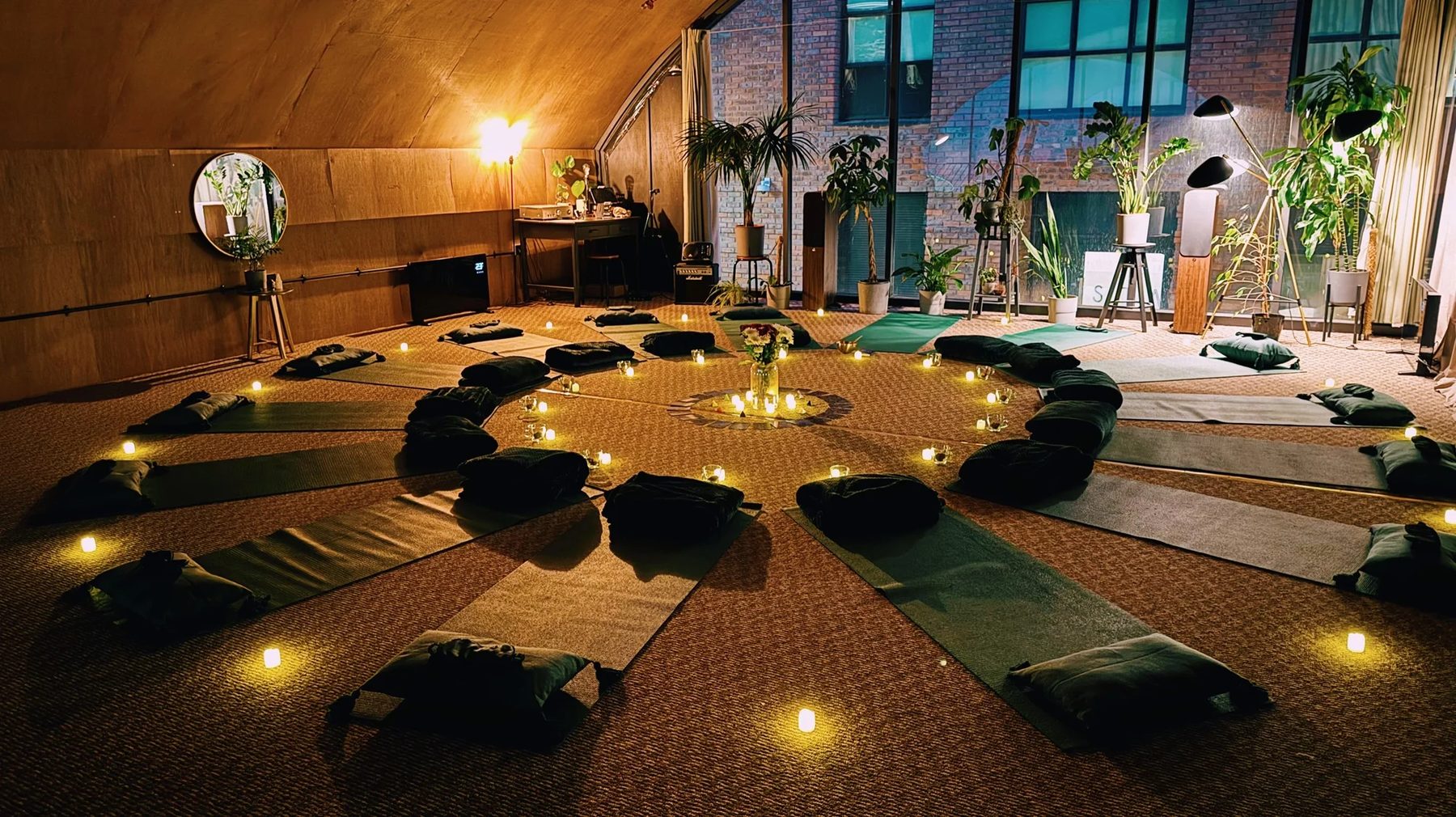 Self-Retreat Studio set for ceremony, mats in a circle around a candlelit altar